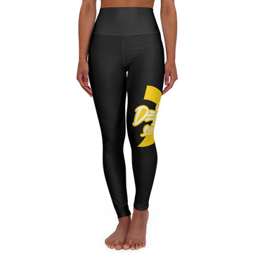 Just Deliver Success Gold High Waisted Yoga Leggings showcased on a model in a standing pose, featuring a bold gold design.