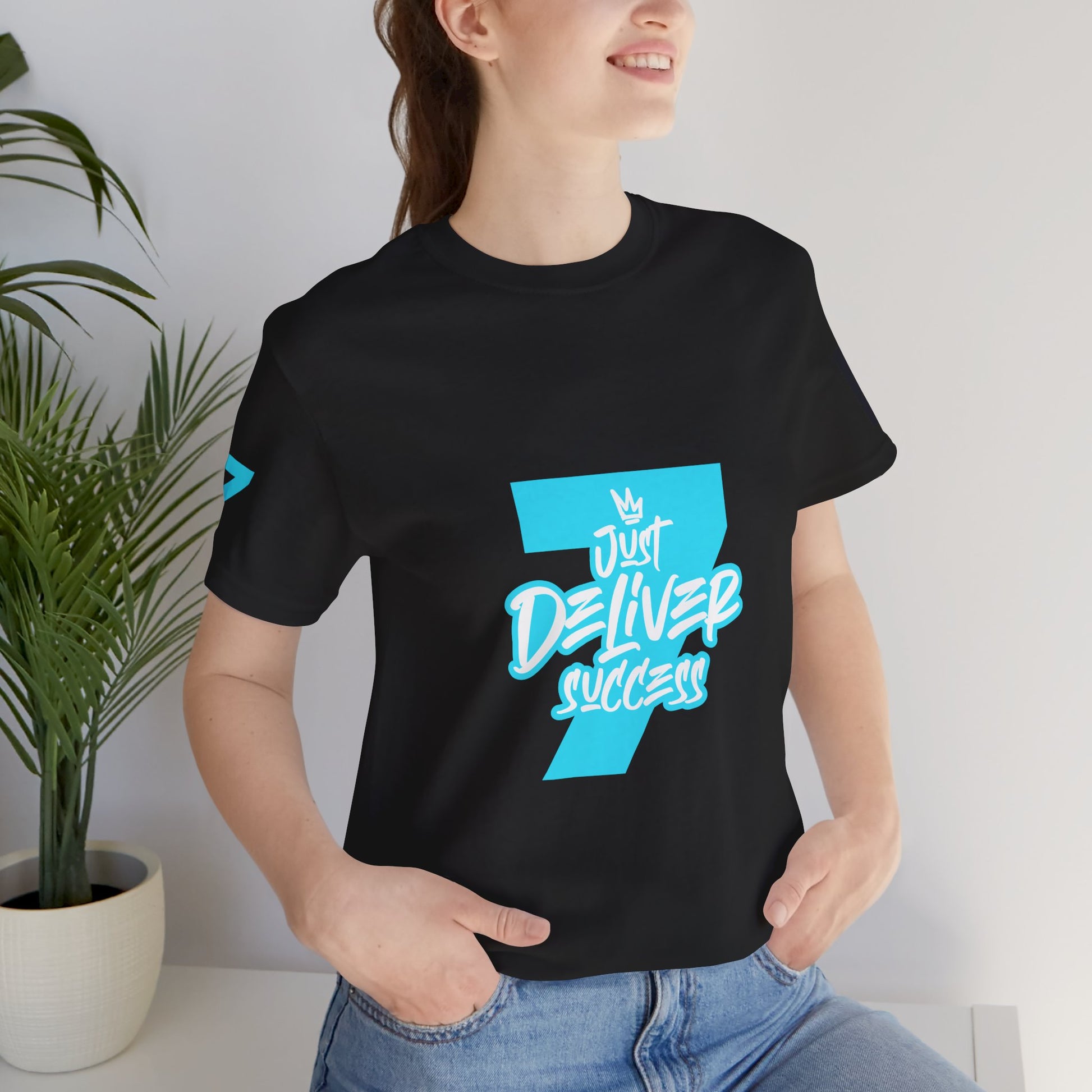 Model wearing Just Deliver Success Light Blue That City 7 Summer Collection t-shirt with vibrant design.
