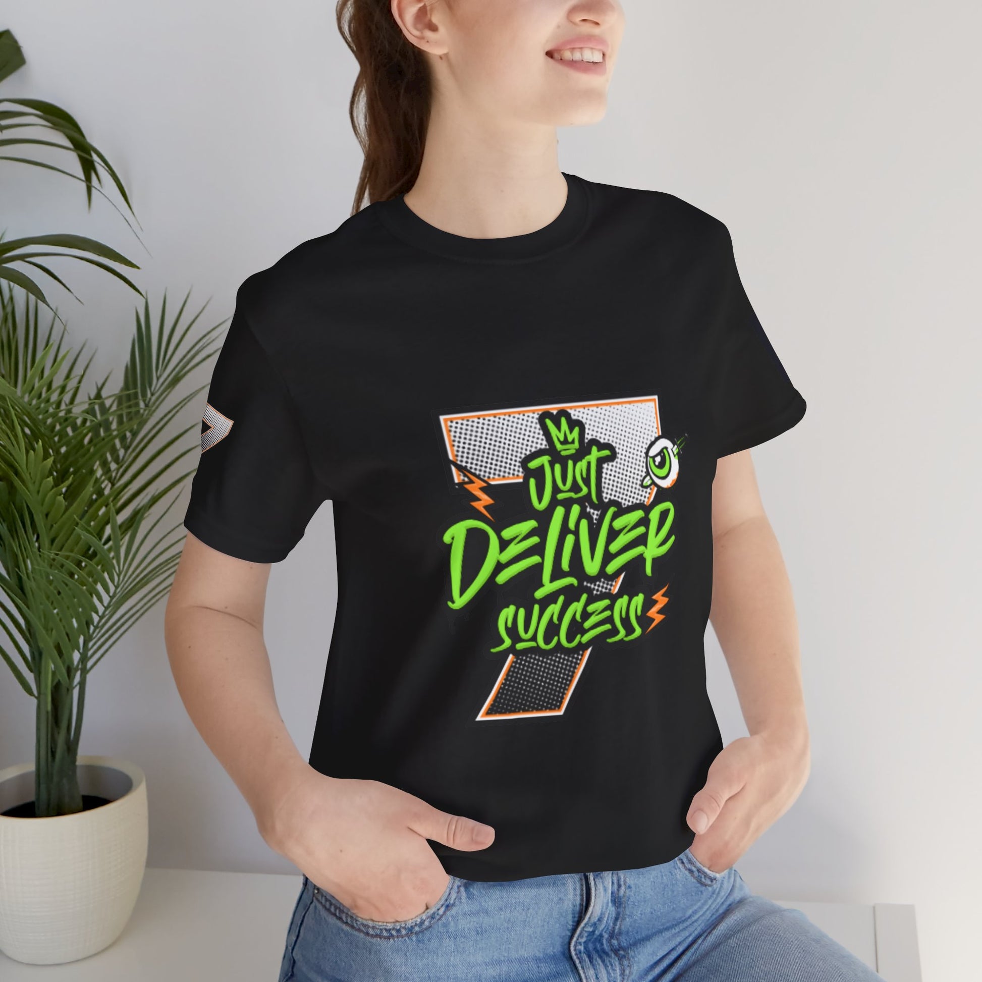 Model wearing a black t-shirt featuring the slogan Just Deliver Success Da Desert That City 7 Summer Collection.