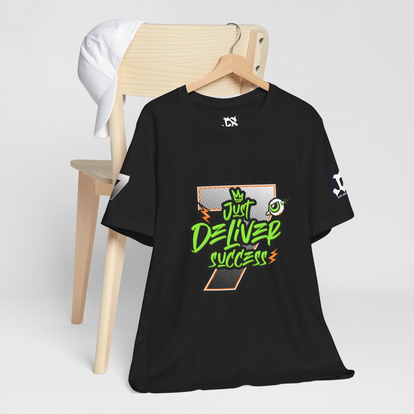 Just Deliver Success Da Desert That City 7 Summer Collection black t-shirt displayed on a chair.