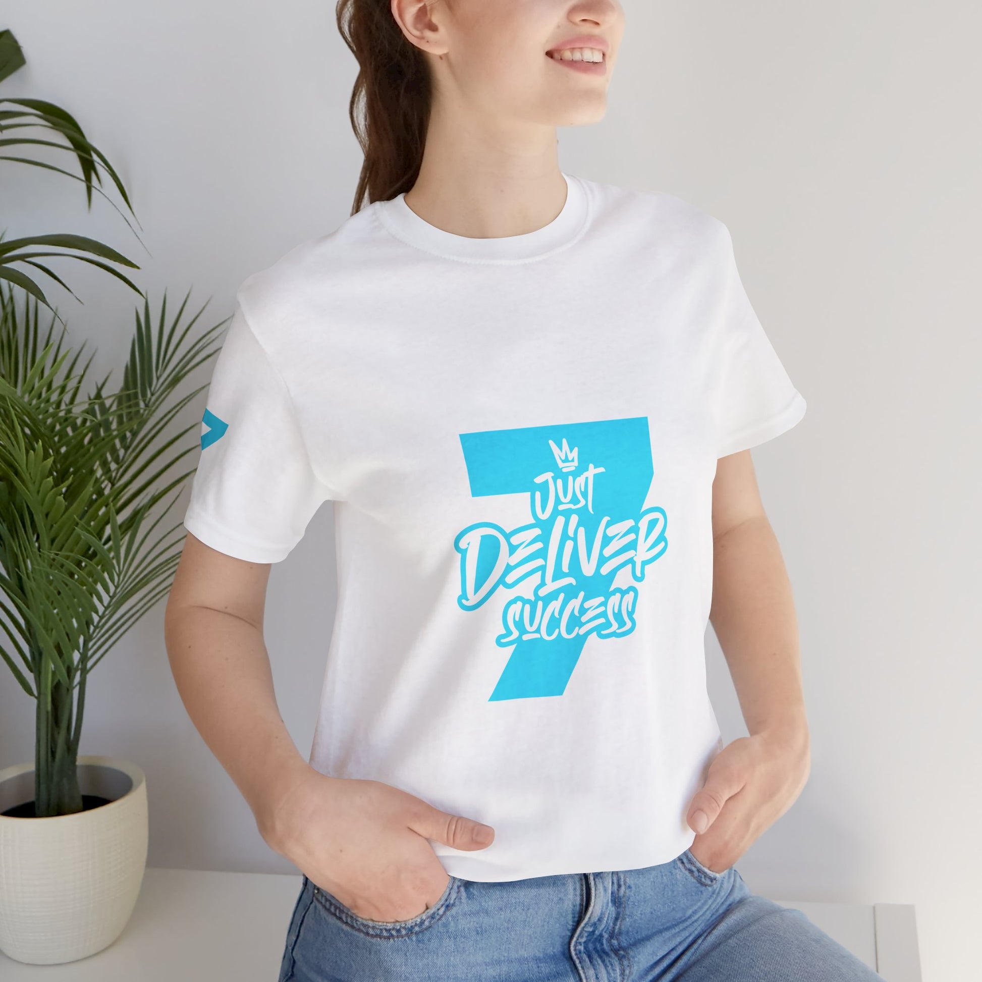 Just Deliver Success Light Blue That City 7 Summer Collection graphic tee worn by a smiling woman.