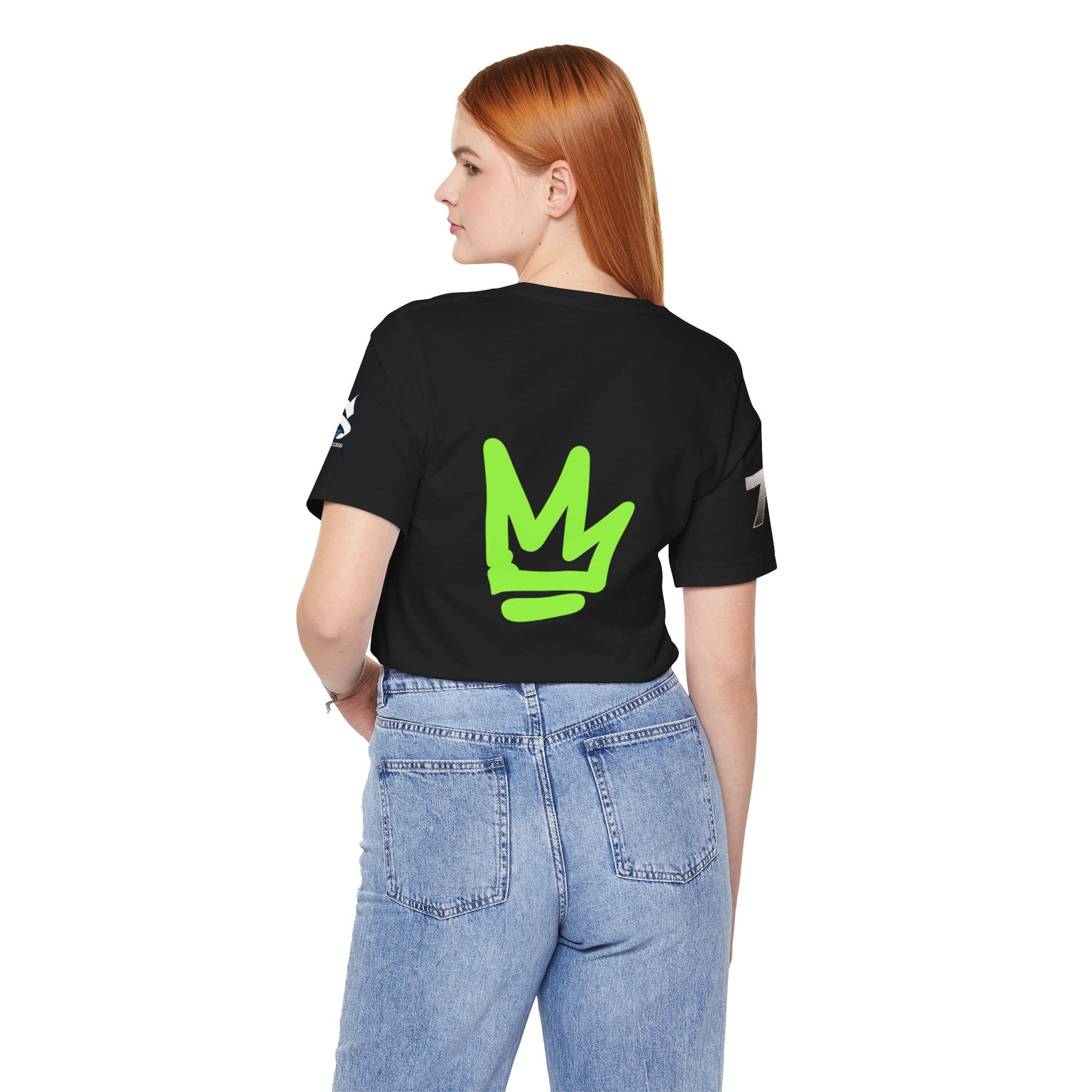 Back view of a model wearing a black t-shirt with green logo, showcasing the Just Deliver Success Da Desert That City 7 Summer Collection.