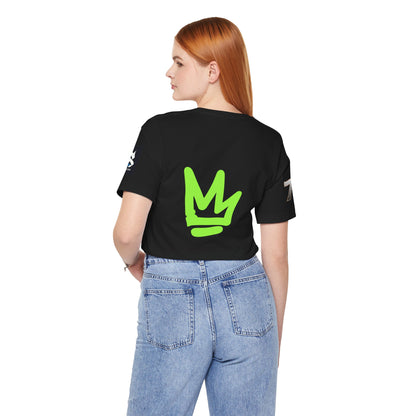Back view of a model wearing a black t-shirt with green logo, showcasing the Just Deliver Success Da Desert That City 7 Summer Collection.