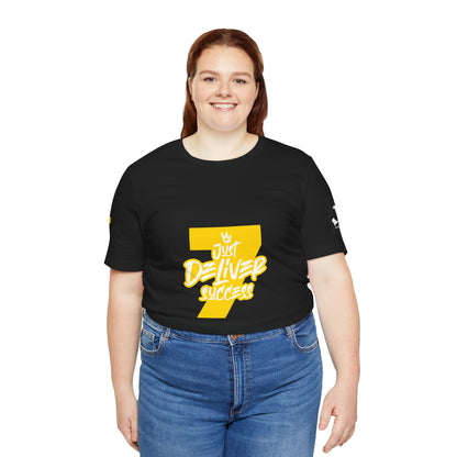 Woman wearing a black t-shirt with the text 'Just Deliver Success 7' for the collection Just Deliver Success Gold That City 7 Summer Collection.