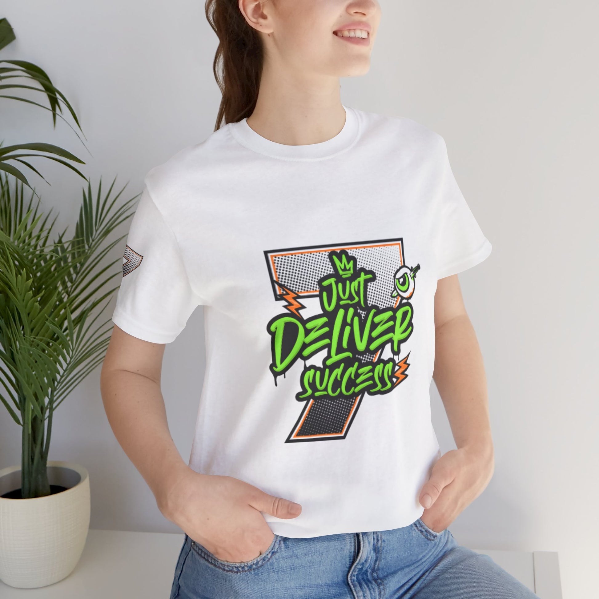 Model wearing a white t-shirt with 'Just Deliver Success Da Desert That City 7 Summer Collection' graphic design.